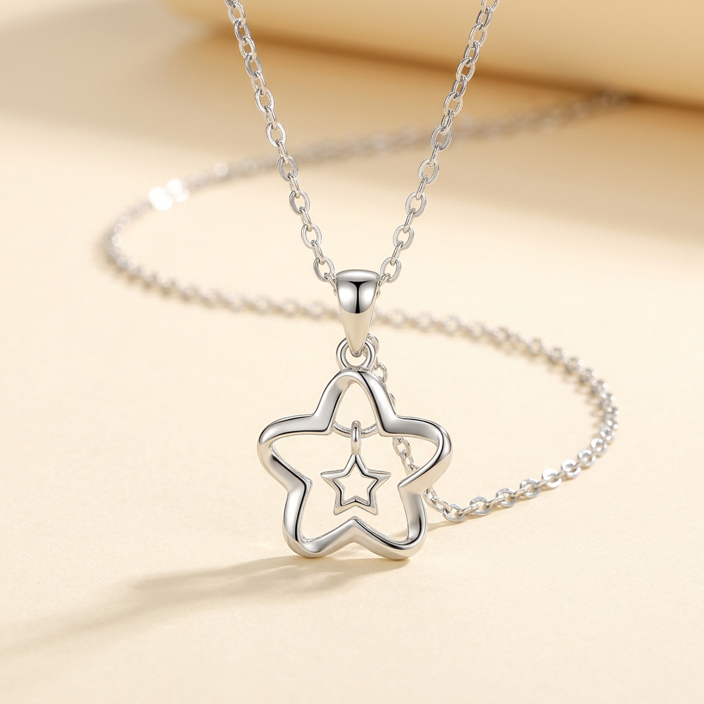 Silver-tone open star necklace with a smaller hanging star on ivory