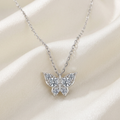 Silver moissanite butterfly necklace on ivory satin
