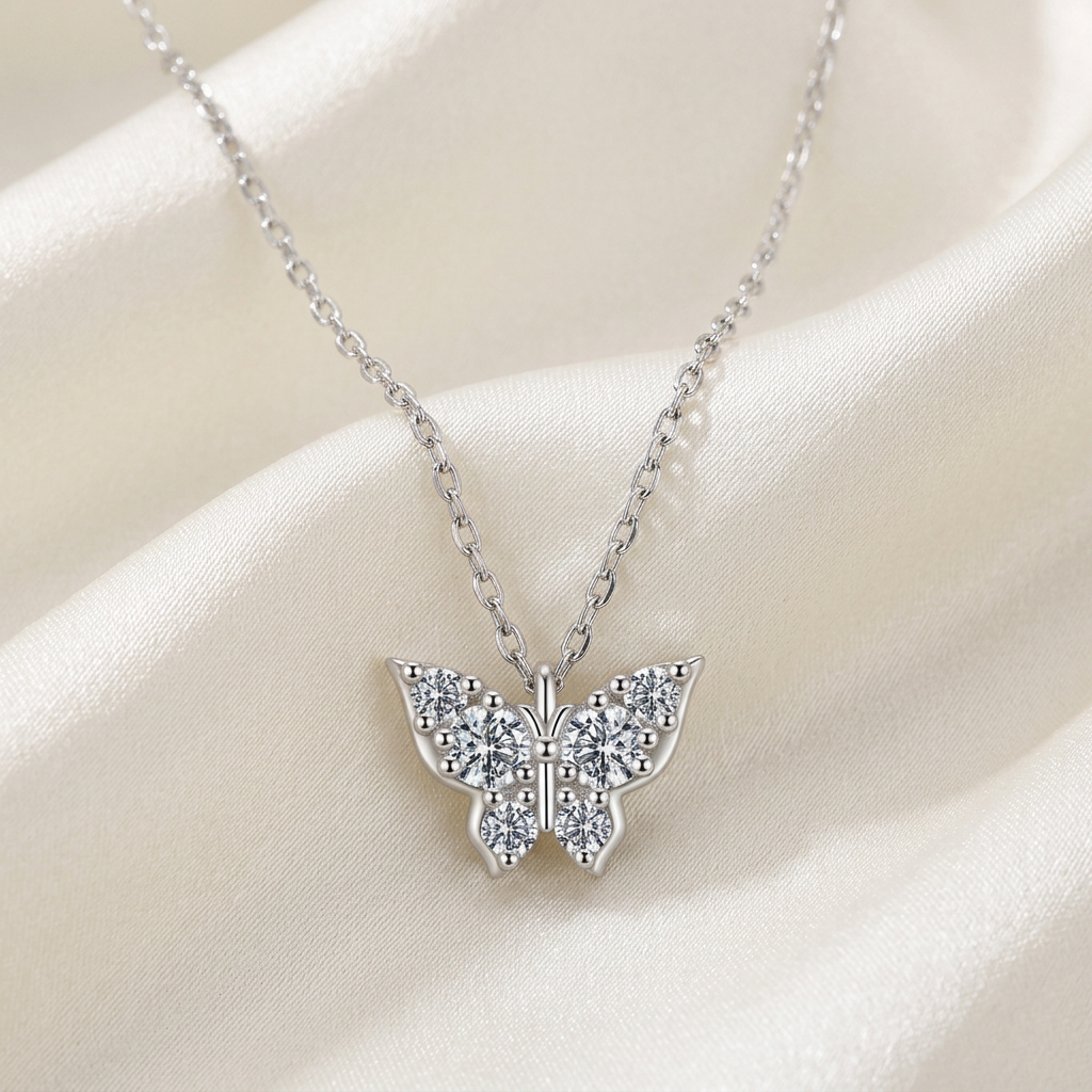 Silver moissanite butterfly necklace on ivory satin