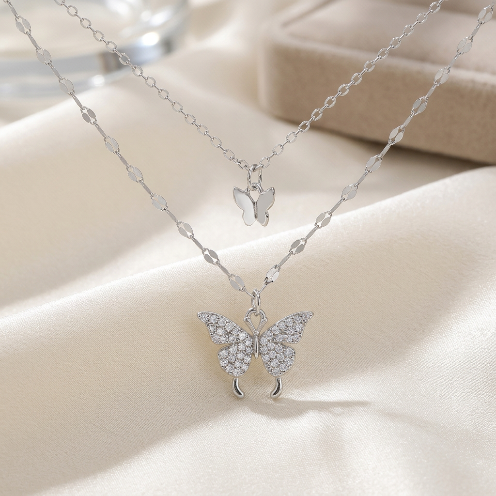 Silver-tone double-layer butterfly necklace on ivory silk