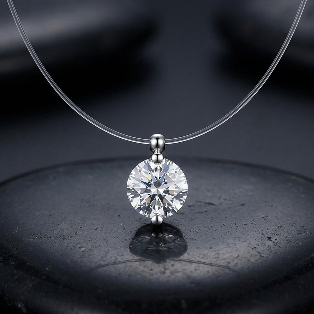 Close-up of round rhinestone pendant on transparent cord against charcoal stone
