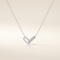 Silver-tone interlocking paperclip necklace on ivory