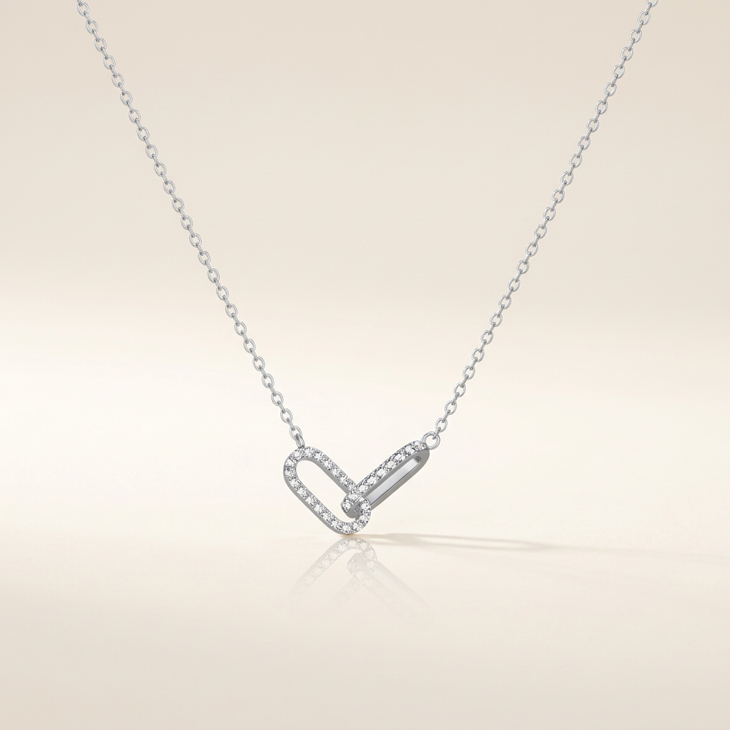 Silver-tone interlocking paperclip necklace on ivory