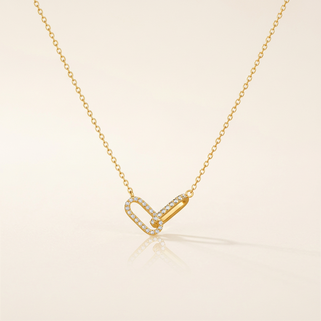 Gold-tone interlocking paperclip necklace on ivory