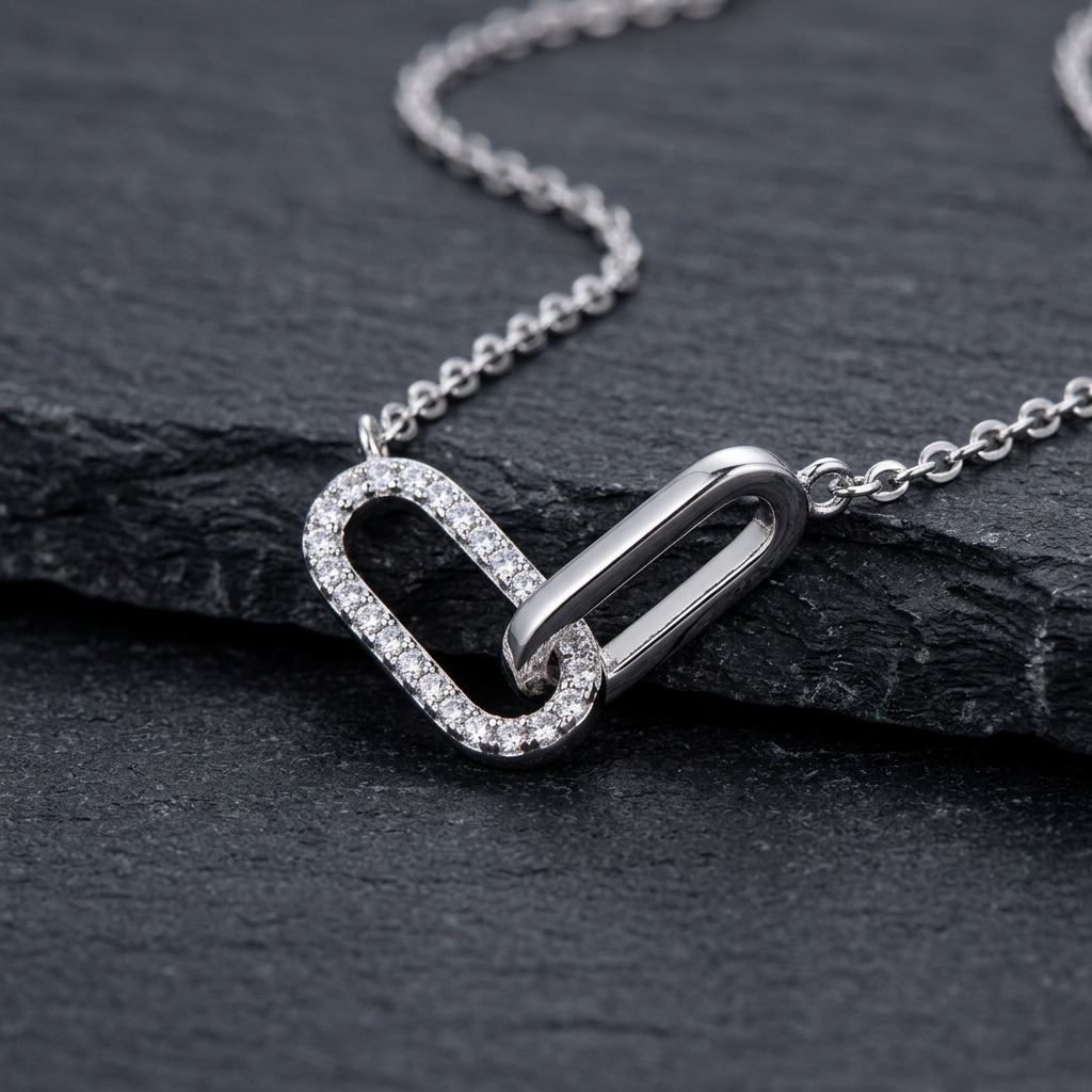 Close-up of silver-tone interlocking links with clear accents