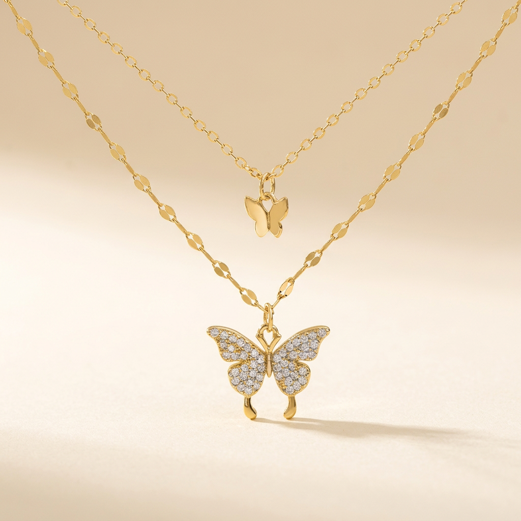 Gold-tone layered butterfly necklace on an ivory background