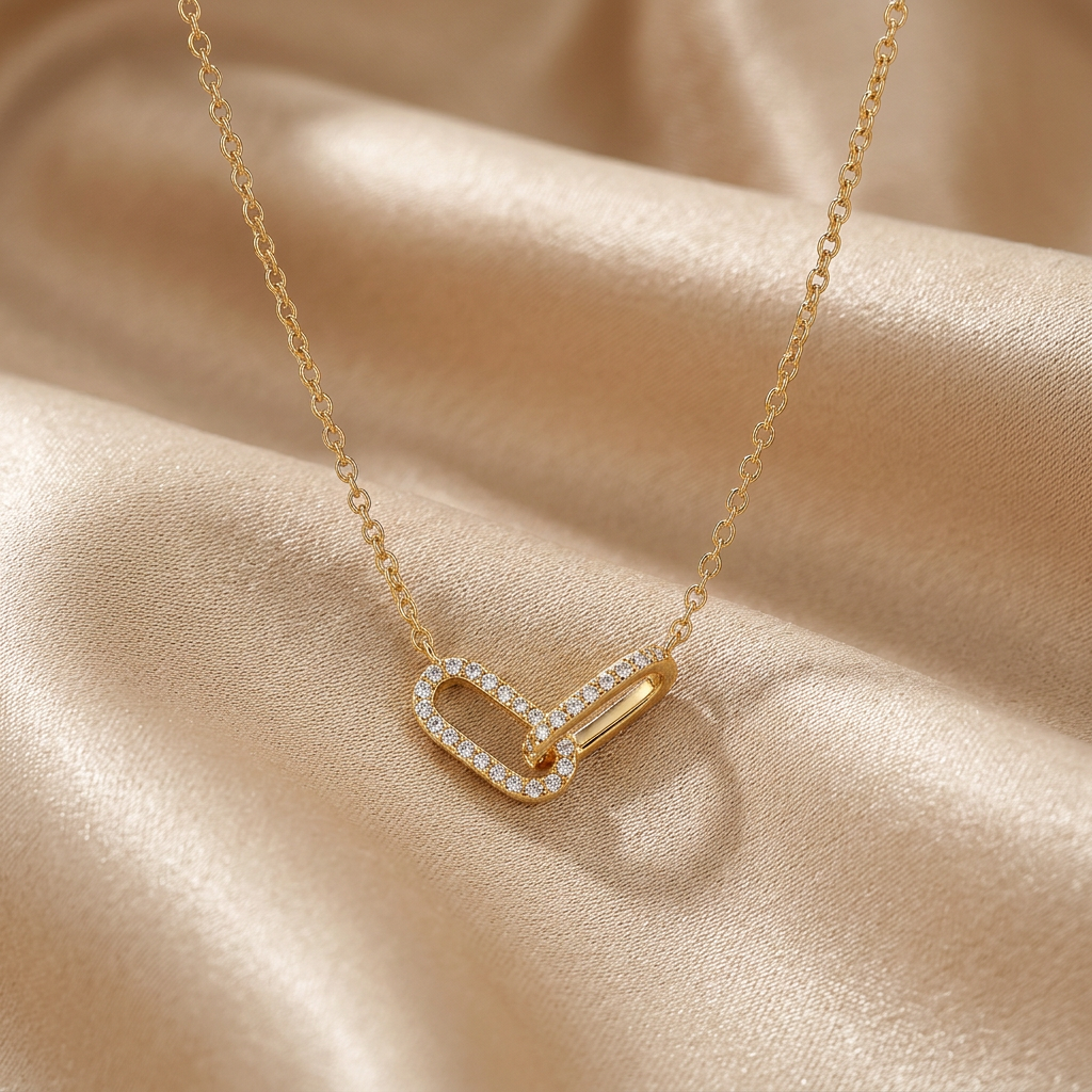 Gold-tone paperclip link necklace on champagne silk