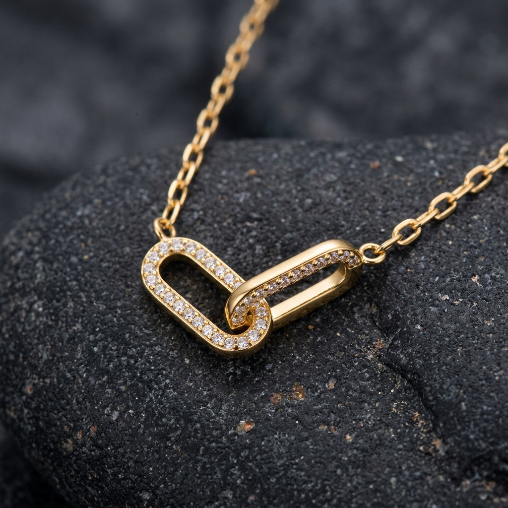 Close-up of gold-tone interlocking links with clear accents