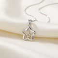 Silver-tone nested-star pendant and link chain on ivory silk