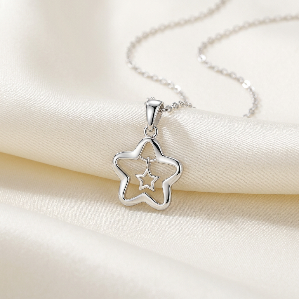 Silver-tone nested-star pendant and link chain on ivory silk