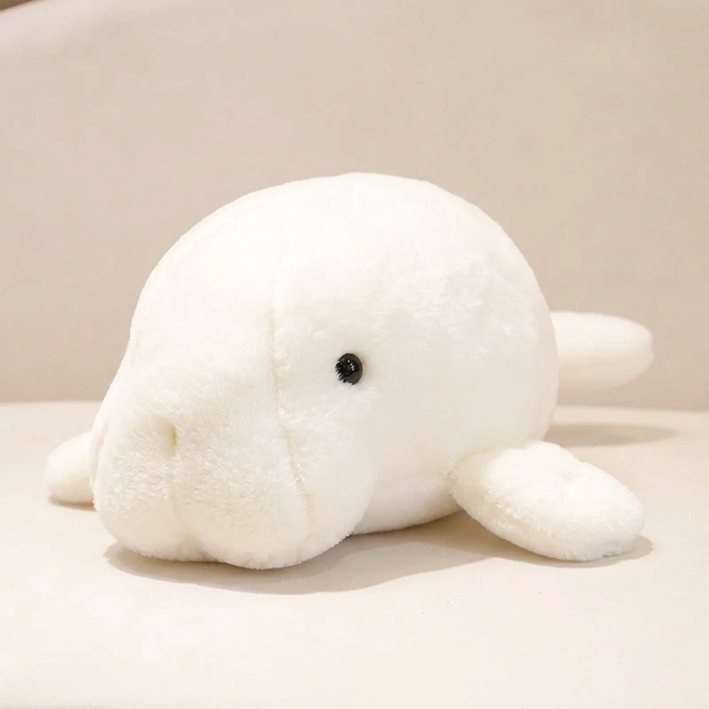 White chubby manatee plushie on soft cream background