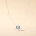 Floating rhinestone necklace with a transparent cord on an ivory background