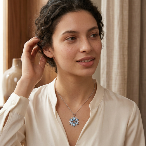Model wearing snowflake necklace in three-quarter pose